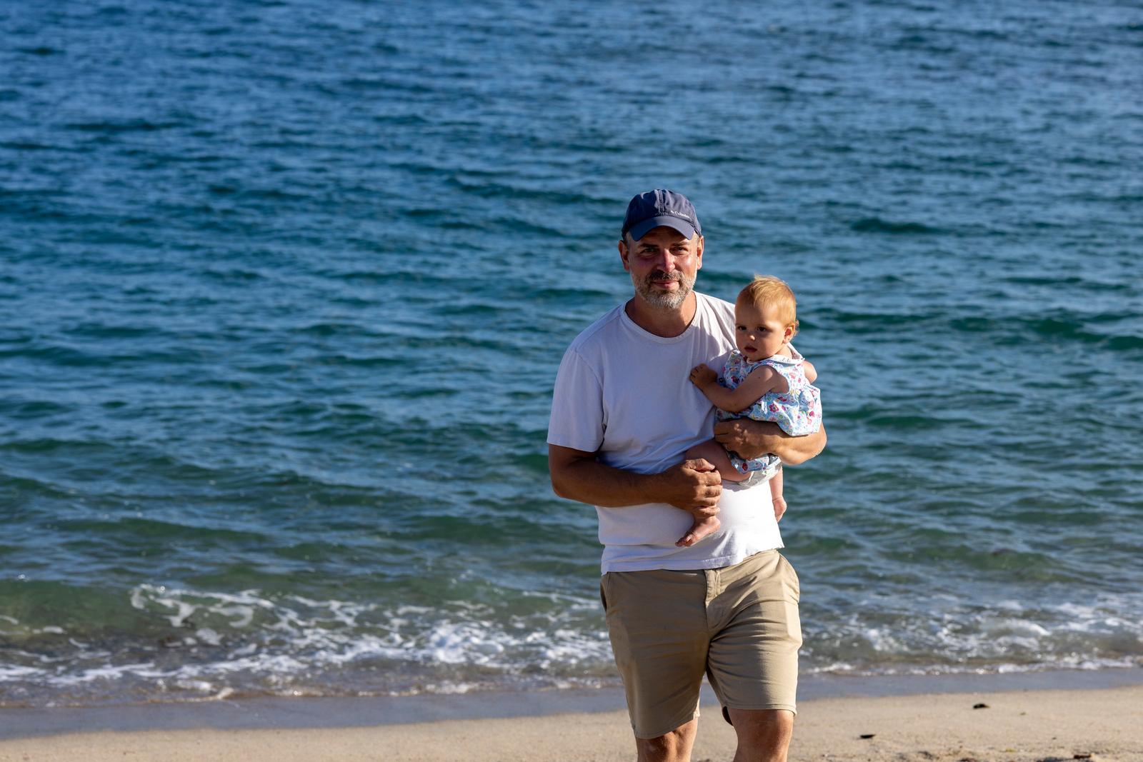 Father and baby by the sea
