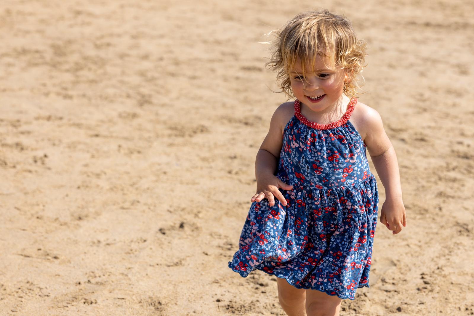 Toddler running on the beach